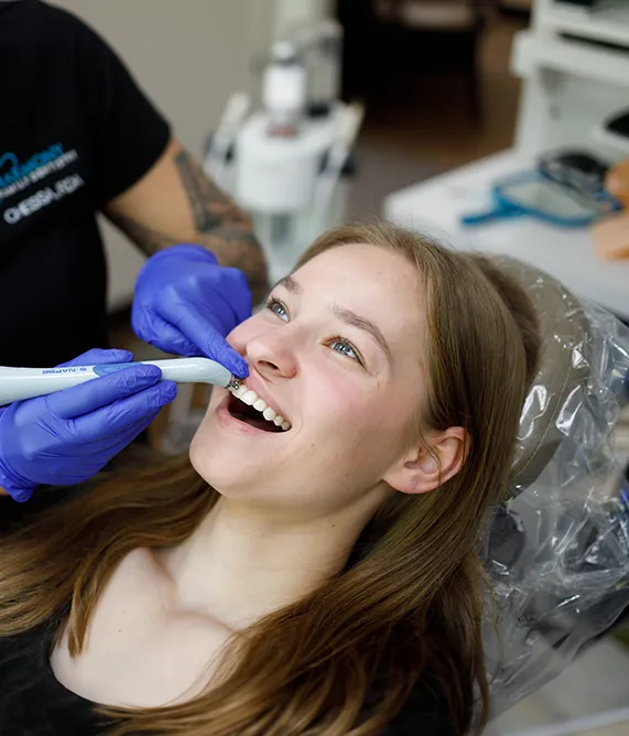 Dental assistant inspecting a patient's teeth - Harmony Family Dentistry in Vancouver WA