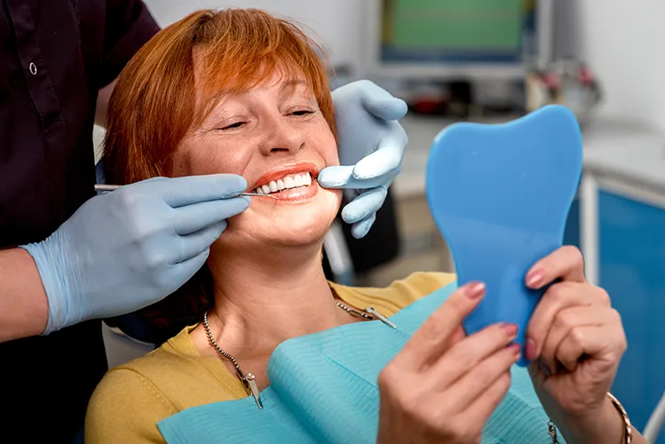 Patient in a dentists chair smiling with dental implants - Harmony Family Dentistry in Vancouver WA