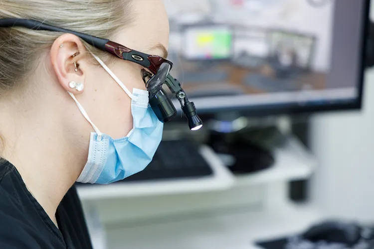 Dental technician inspecting a patient's teeth - Harmony Family Dentistry in Vancouver WA