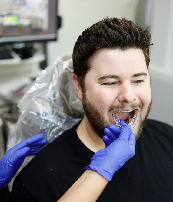 Patient getting a pair of invisalign aligners removed - Harmony Family Dentistry in Vancouver WA