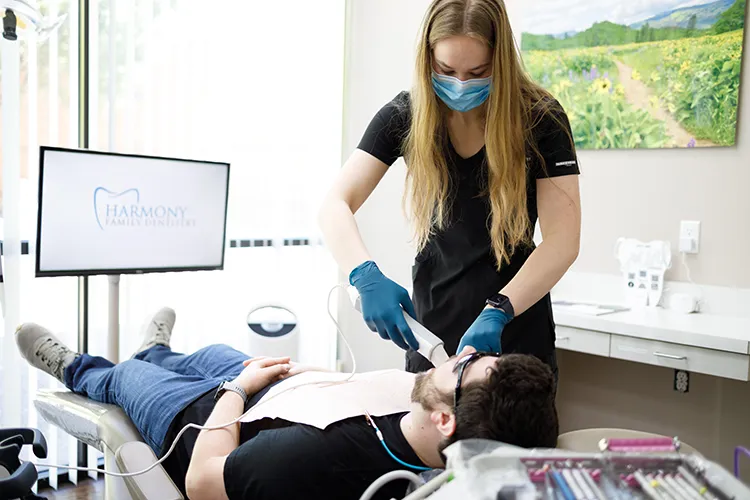 Dental technician treating a patient - Harmony Family Dentistry in Vancouver WA